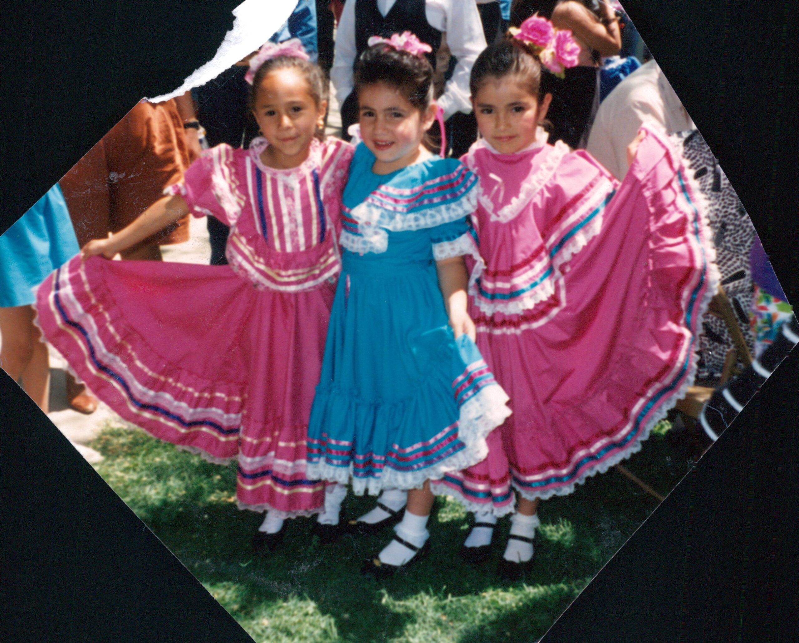 three little girls in traditional Mexican folklorico dresses